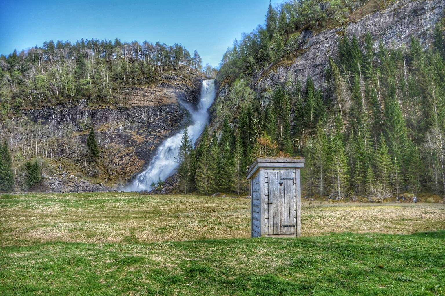 off grid toilet outhouse with waterfall in background