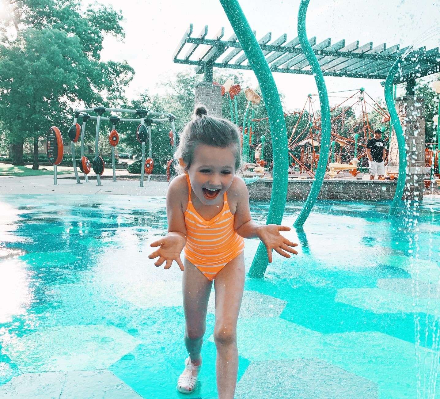 Little girl playing in waterpark.
