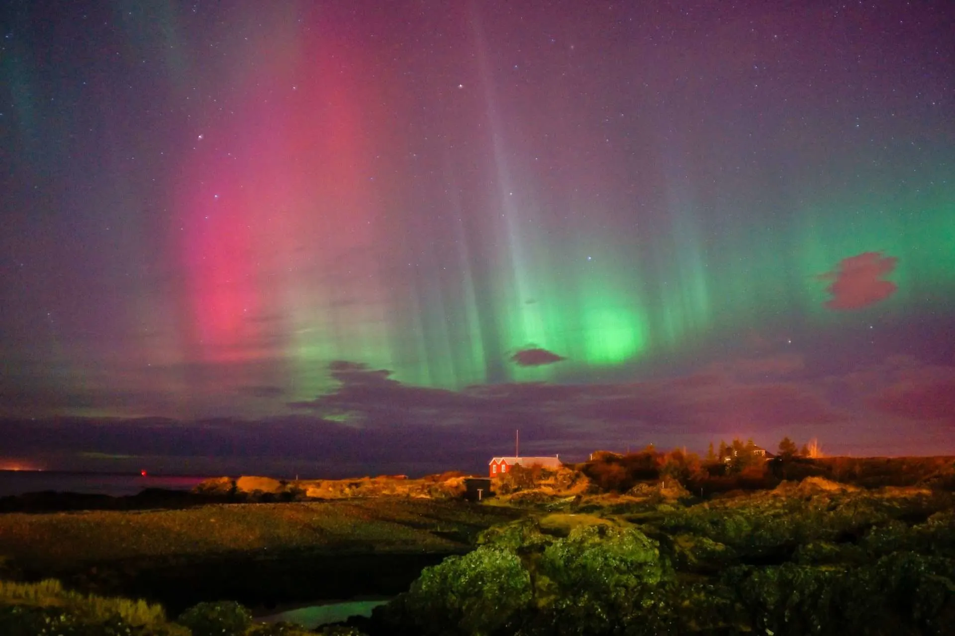 The Northern Lights over a farm.