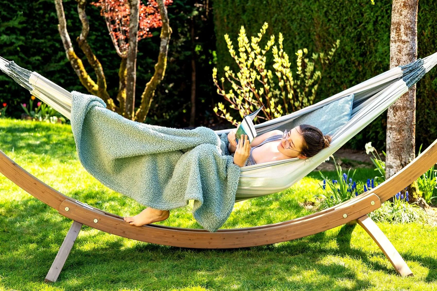 Woman reading in a free-standing hammock.