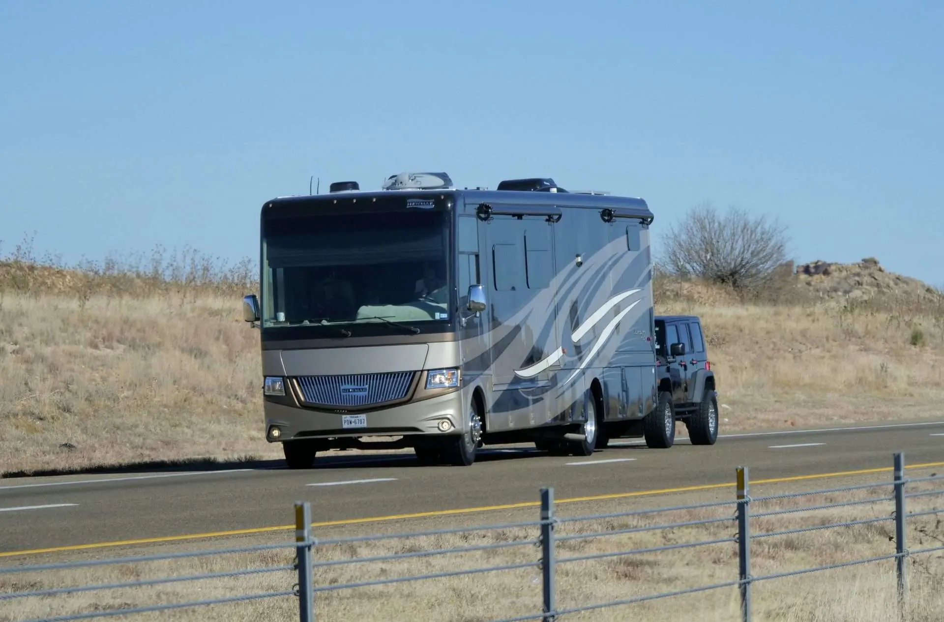 Class A motorhome towing a Jeep
