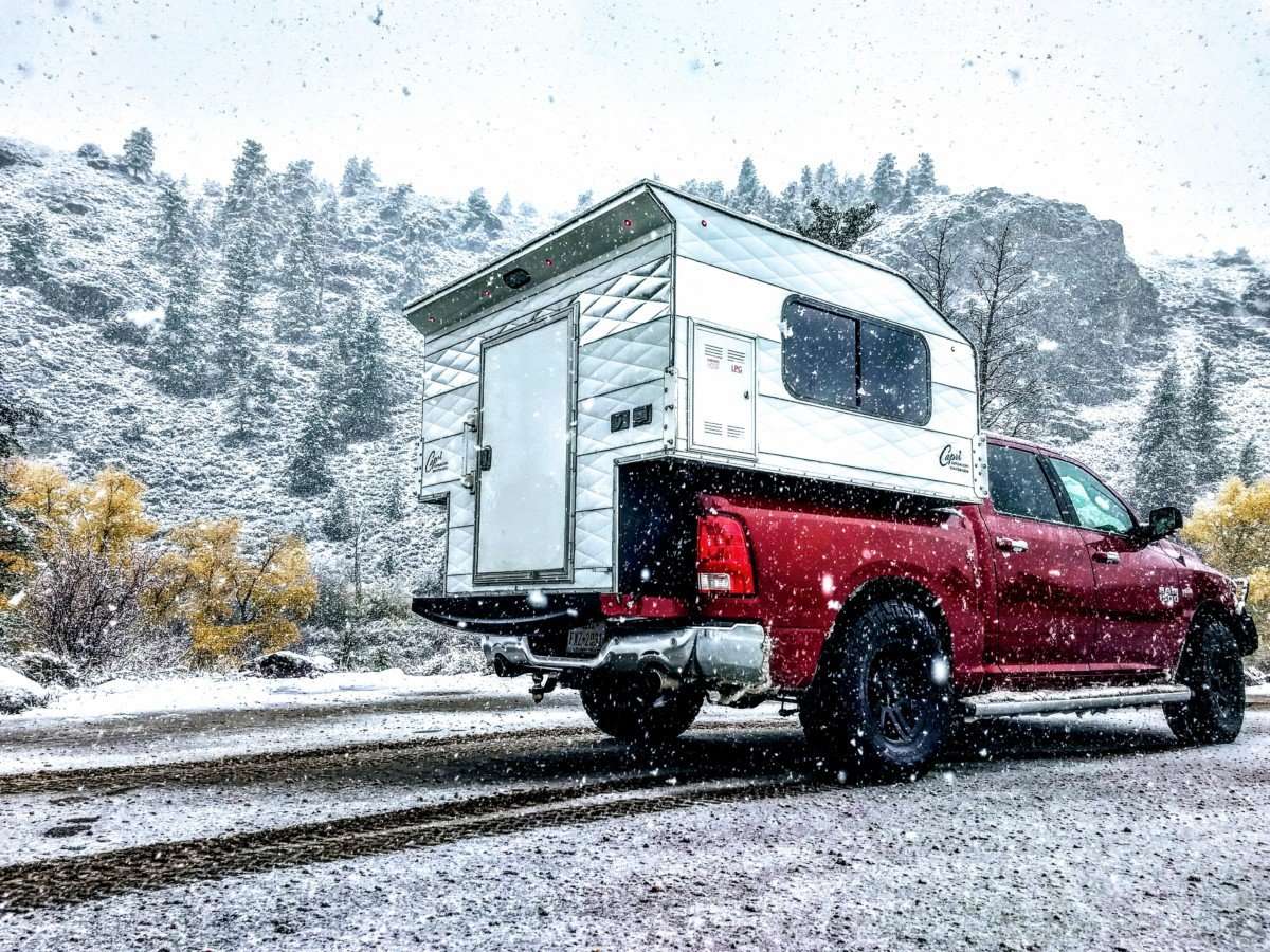 Cowboy model on red truck in snow from Capri Camper