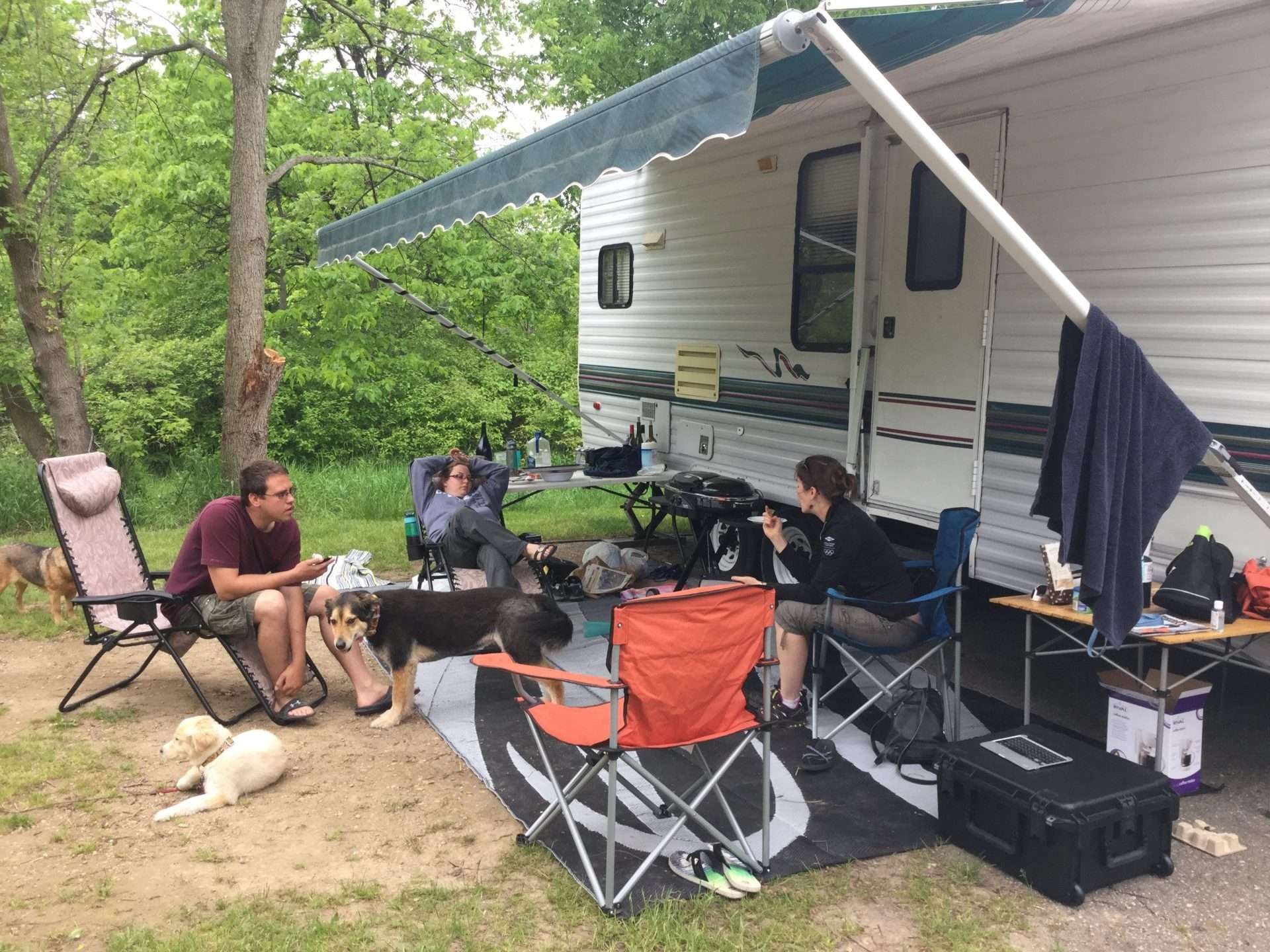Mortons on the Move and friends sitting in front of RV camping