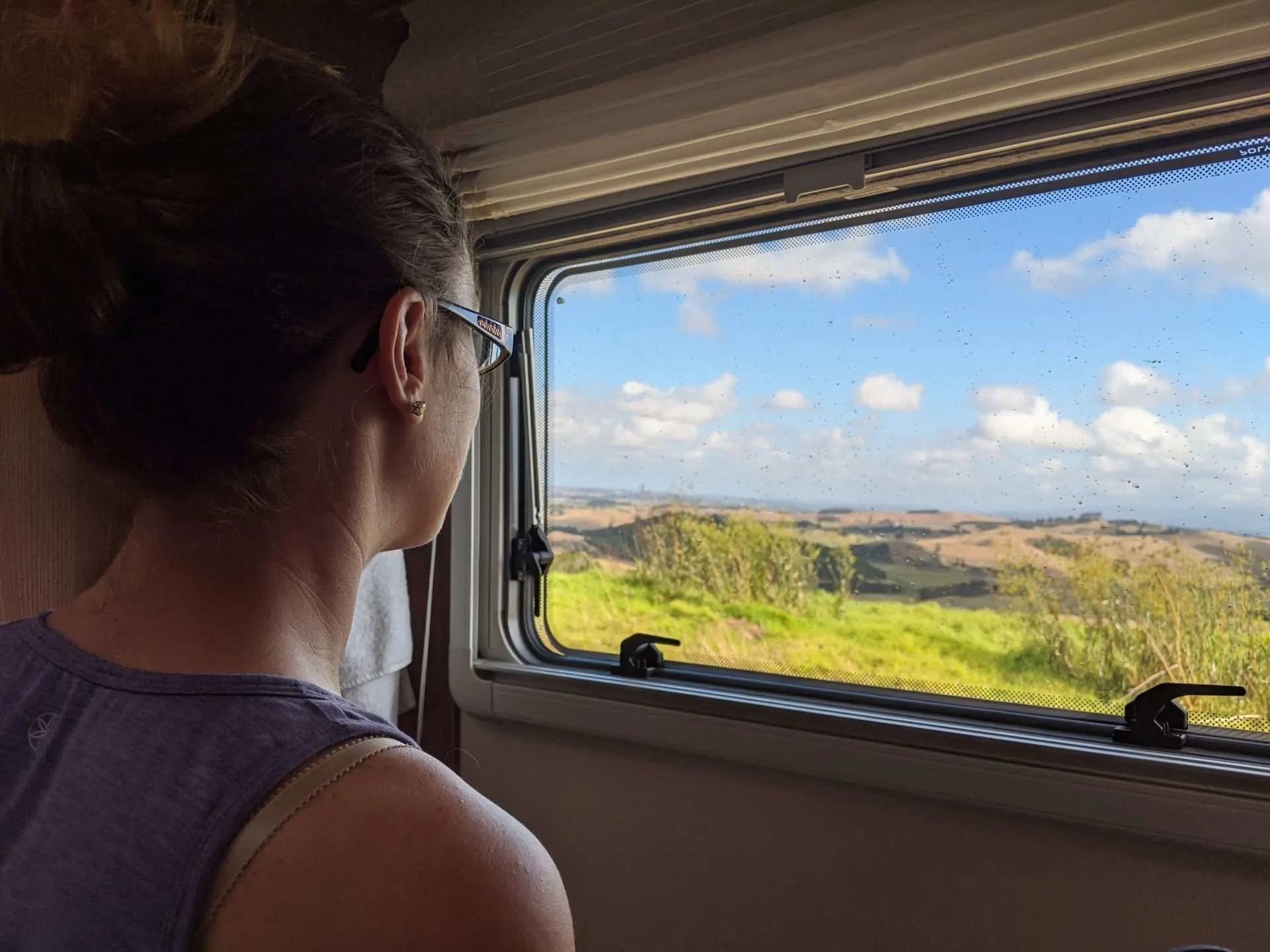 Cait looking out RV window in New Zealand