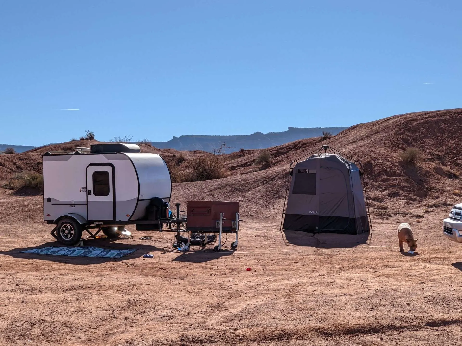 camping setup with tent and guard dog