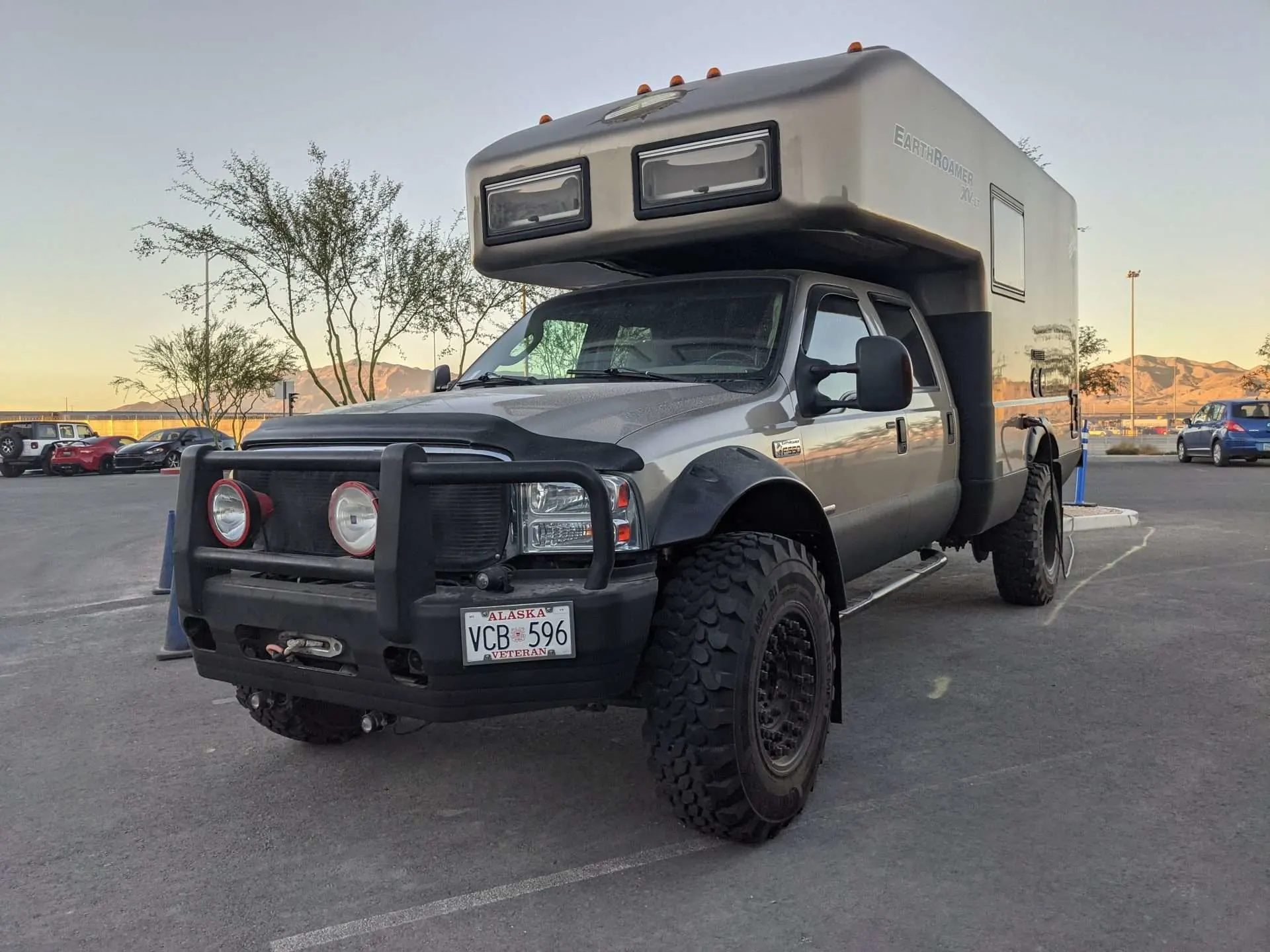 Truck camper parked in parking lot with heavy duty Buckstop bumper installed.