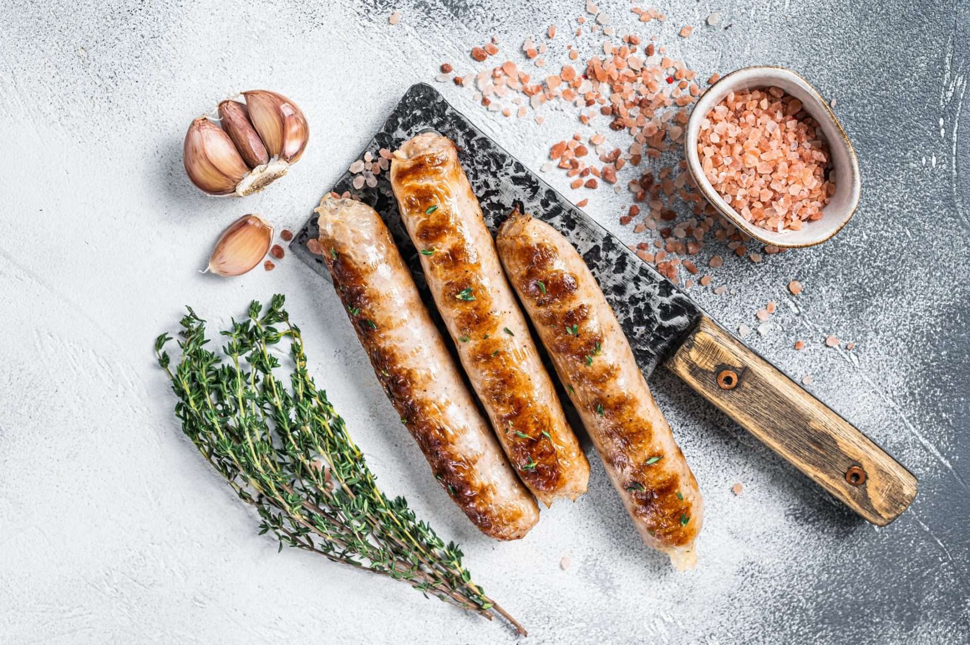 Flat lay image of bratwurst and cooking spices