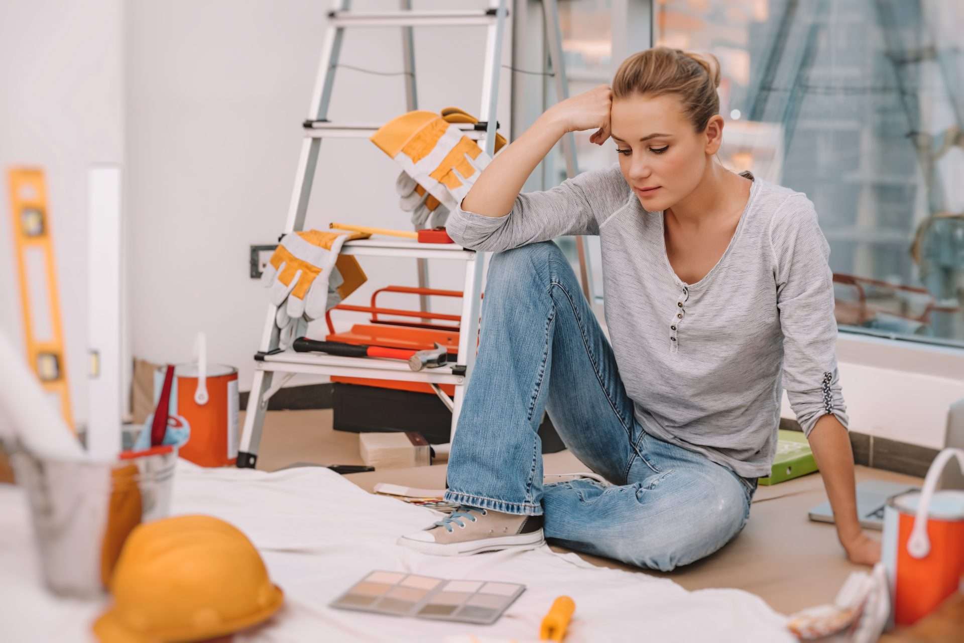 Woman making design decisions while remodeling old camper