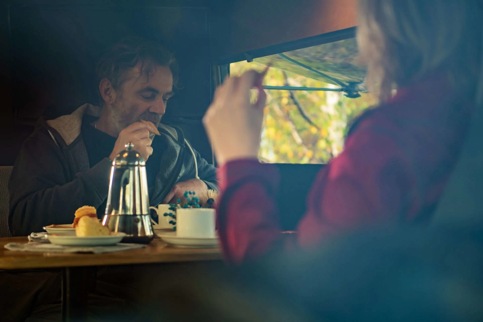 Couple eating breakfast in their RV.