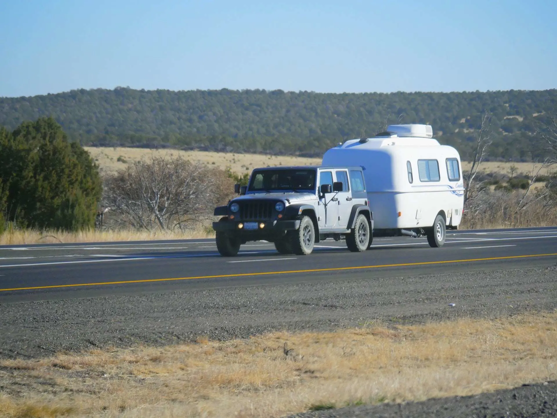 jeep towing a casita camper on highway