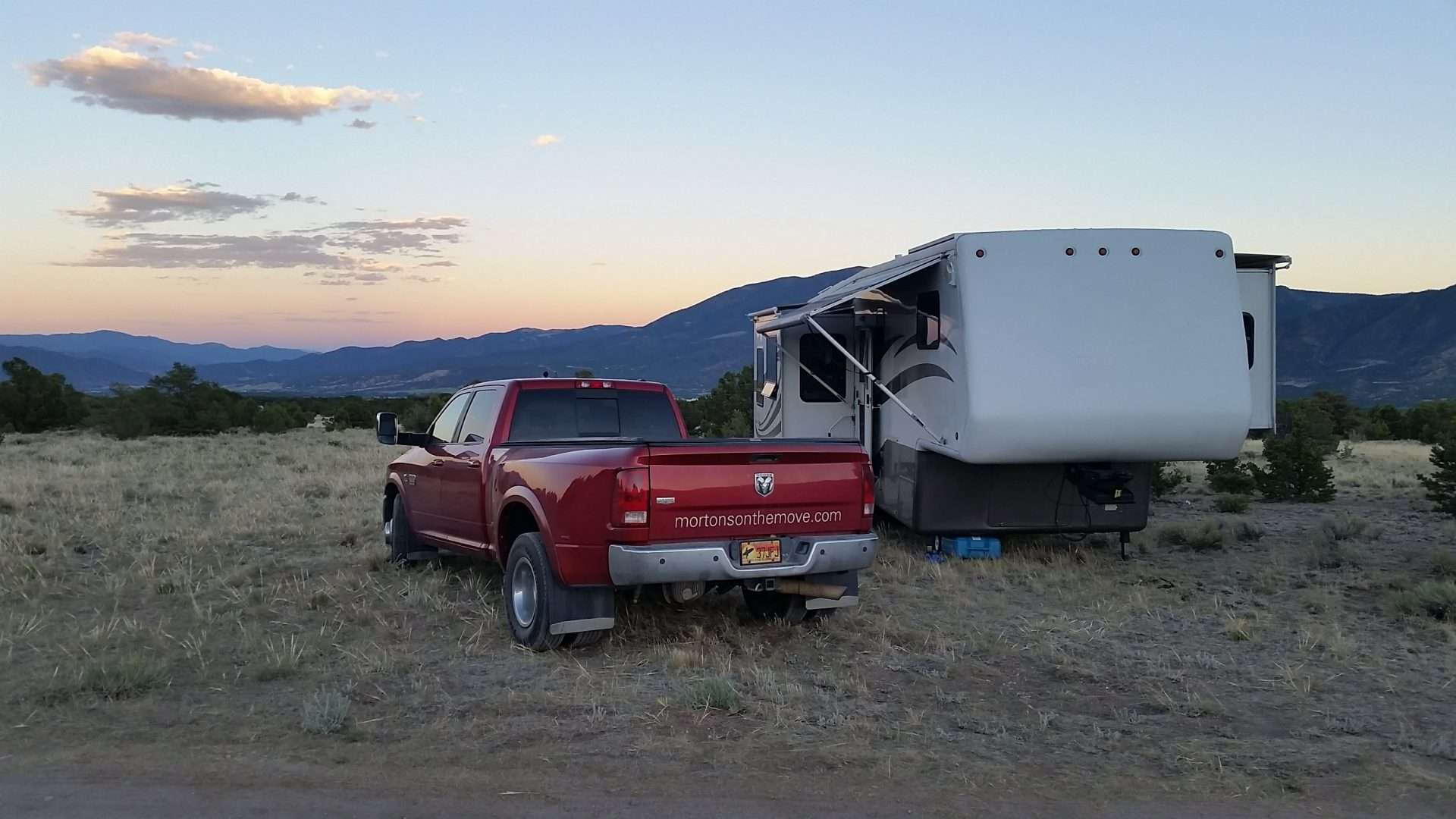 Mortons on the Move truck and fifth wheel parked while boondocking at sunset.