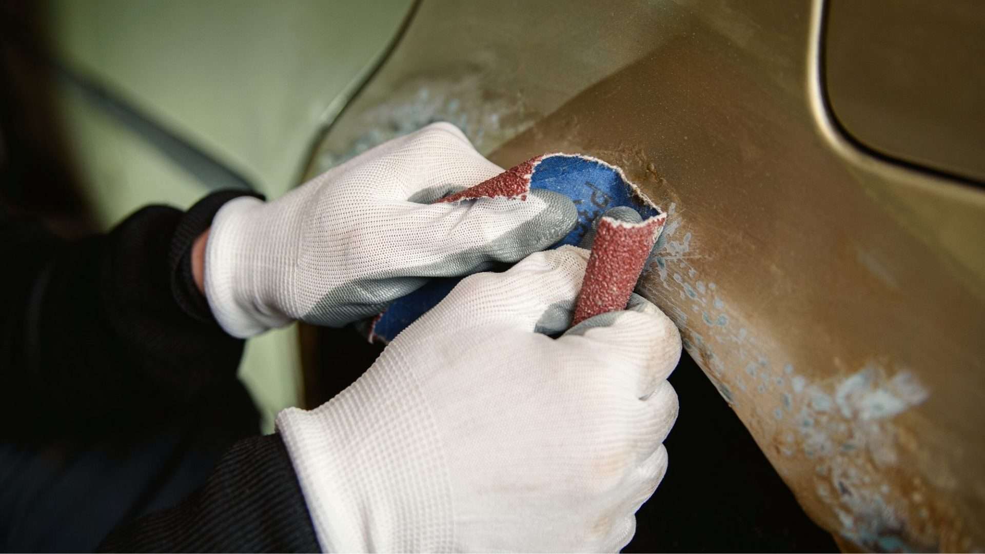 Removing rust from vehicle with sandpaper