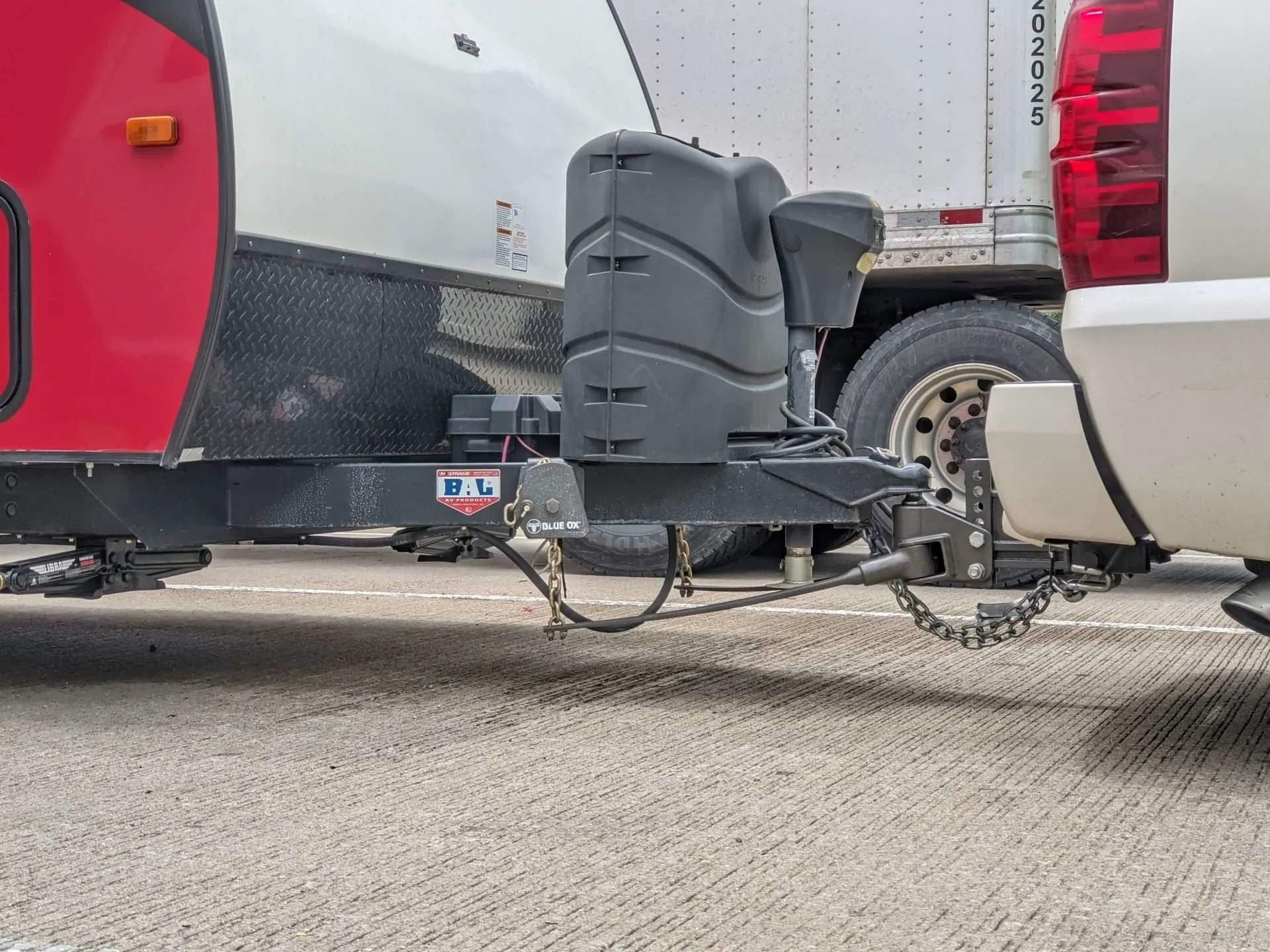 RV trailer hitched to truck with power tongue jack attached