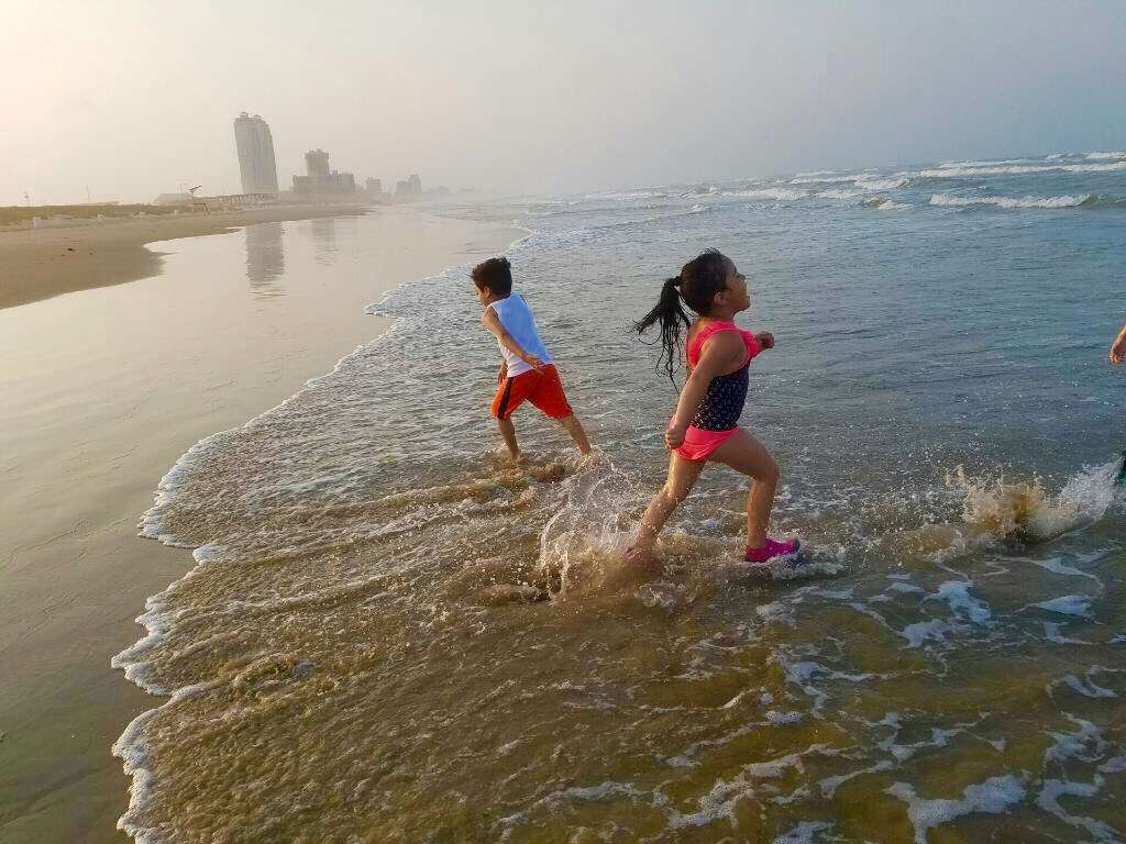 Two kids playing in ocean on South Padre Island