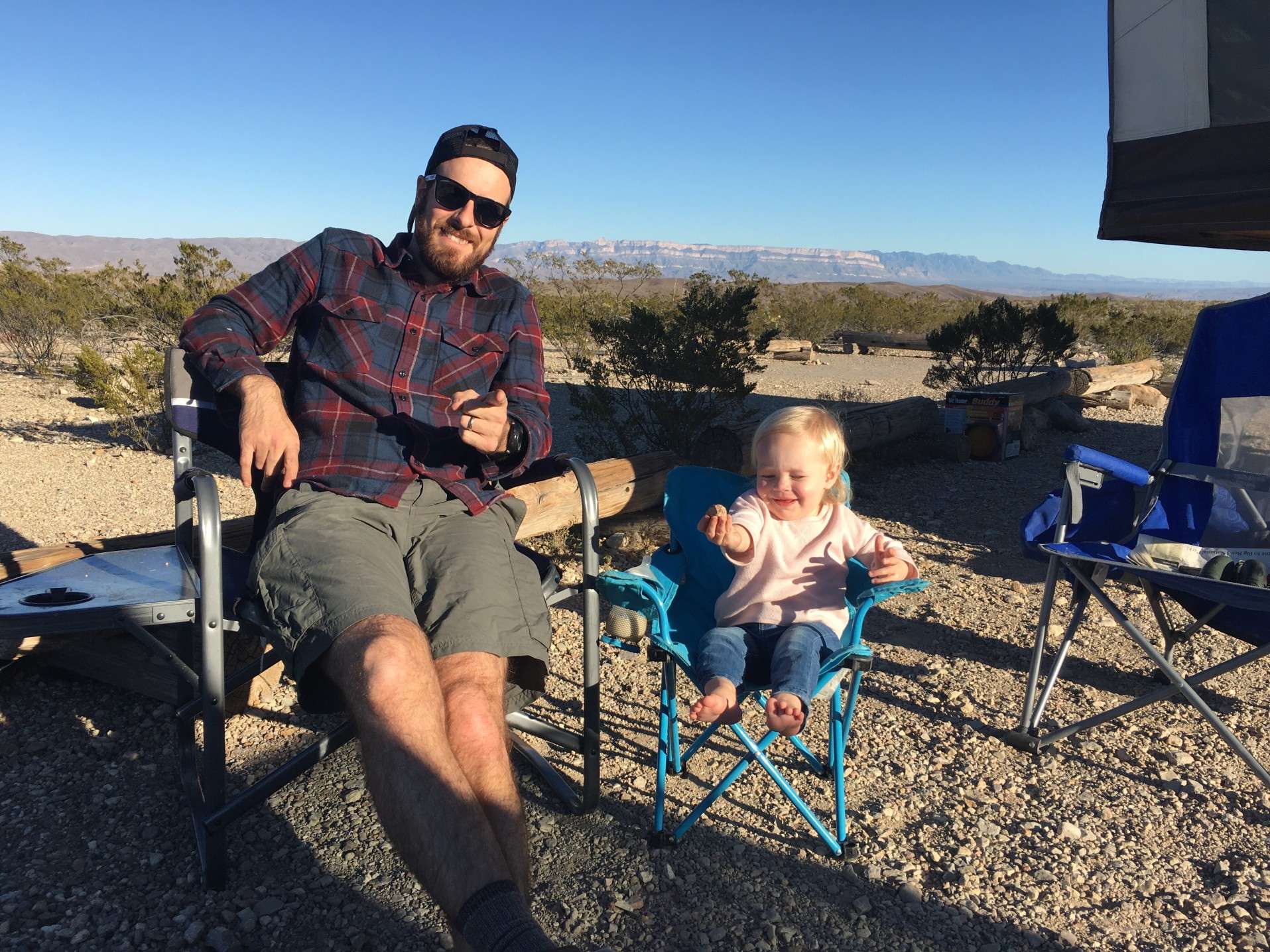 Father and daughter sitting at campsite in Big Bend National Park.