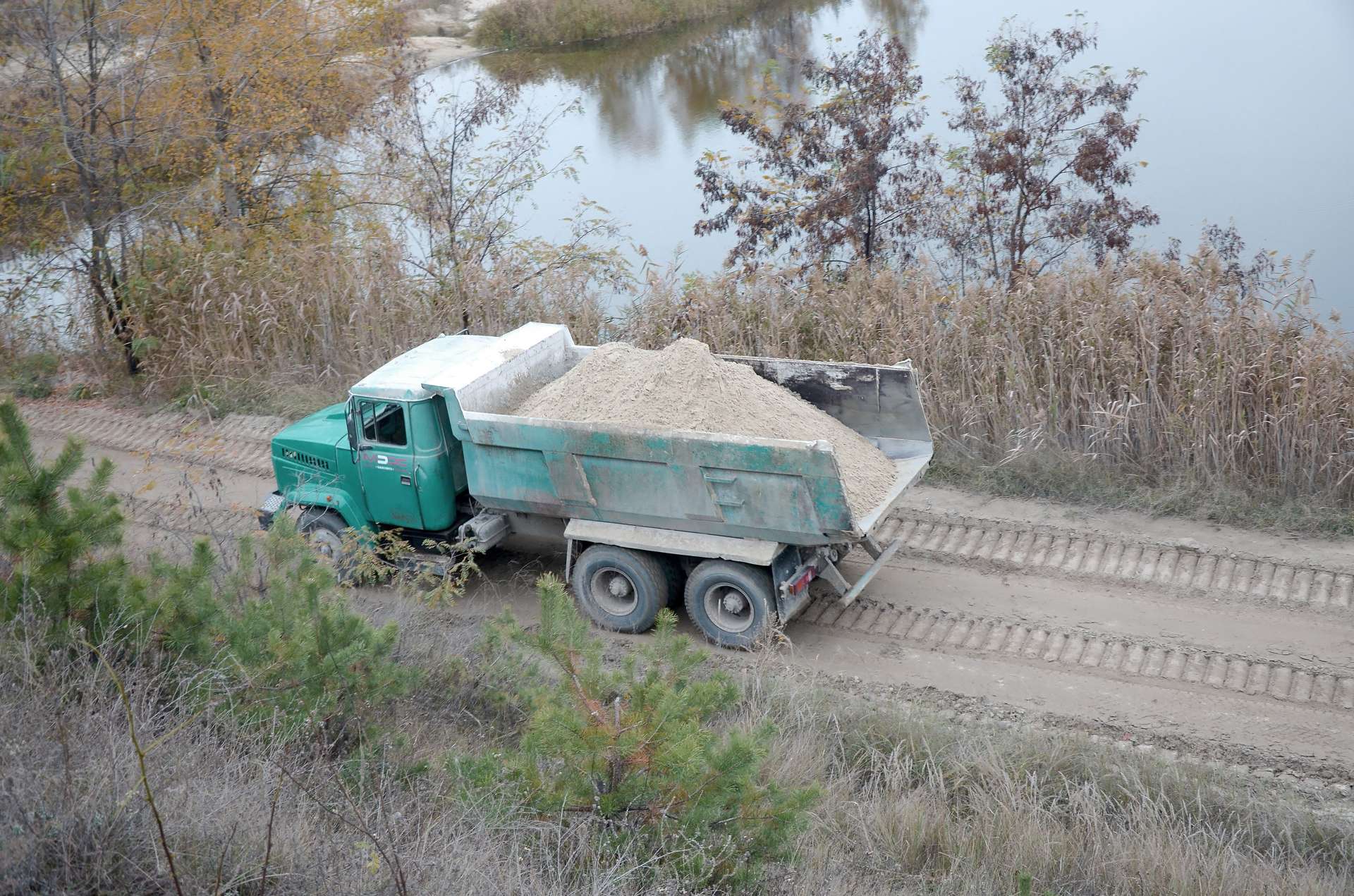 dump truck driving on dirt road