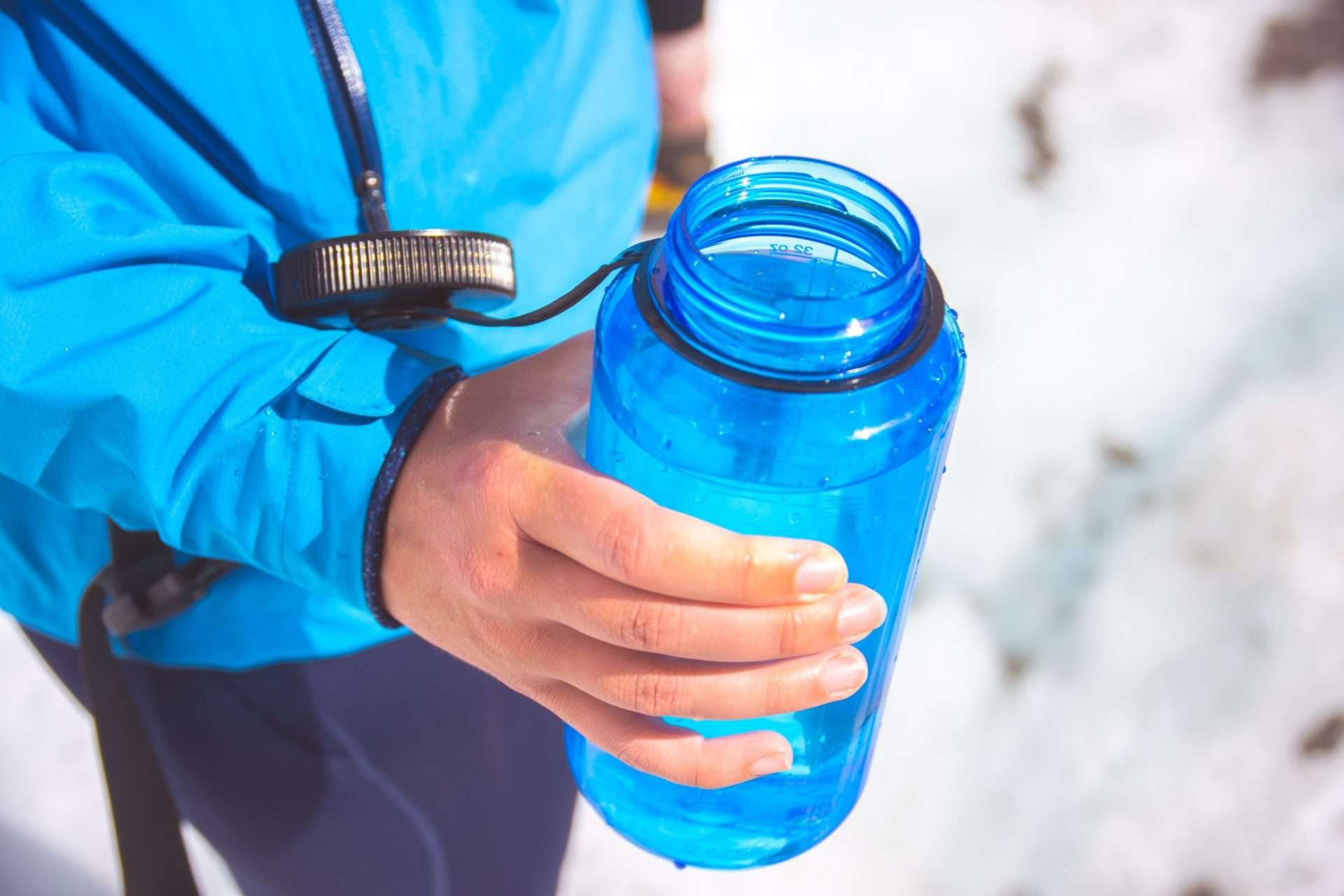 Close up on hiker holding a water bottle