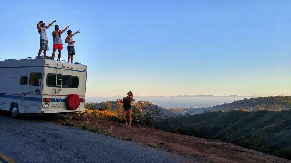 Friends posing on top of RV in Santa Barbara 