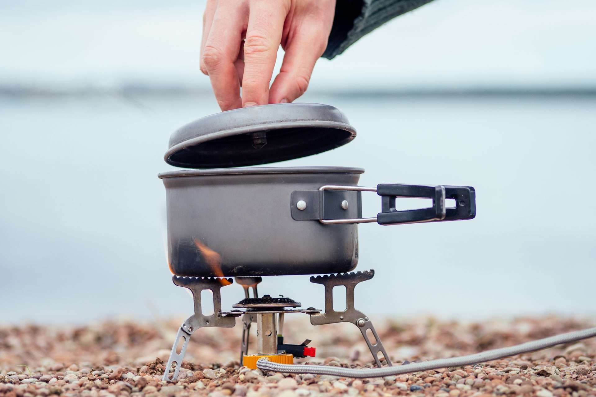 Camping stove being used on the beach.
