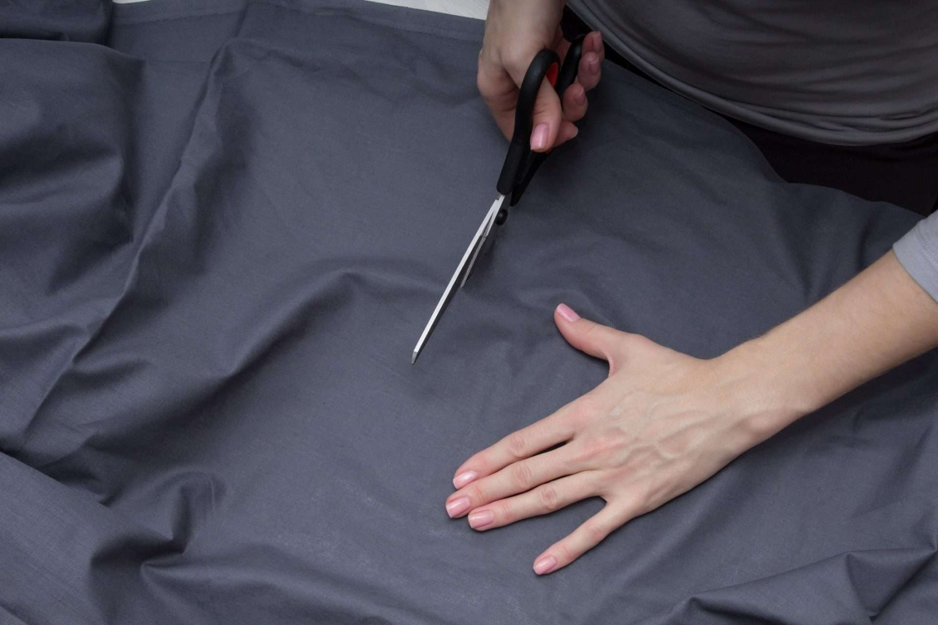 Woman cutting black fabric