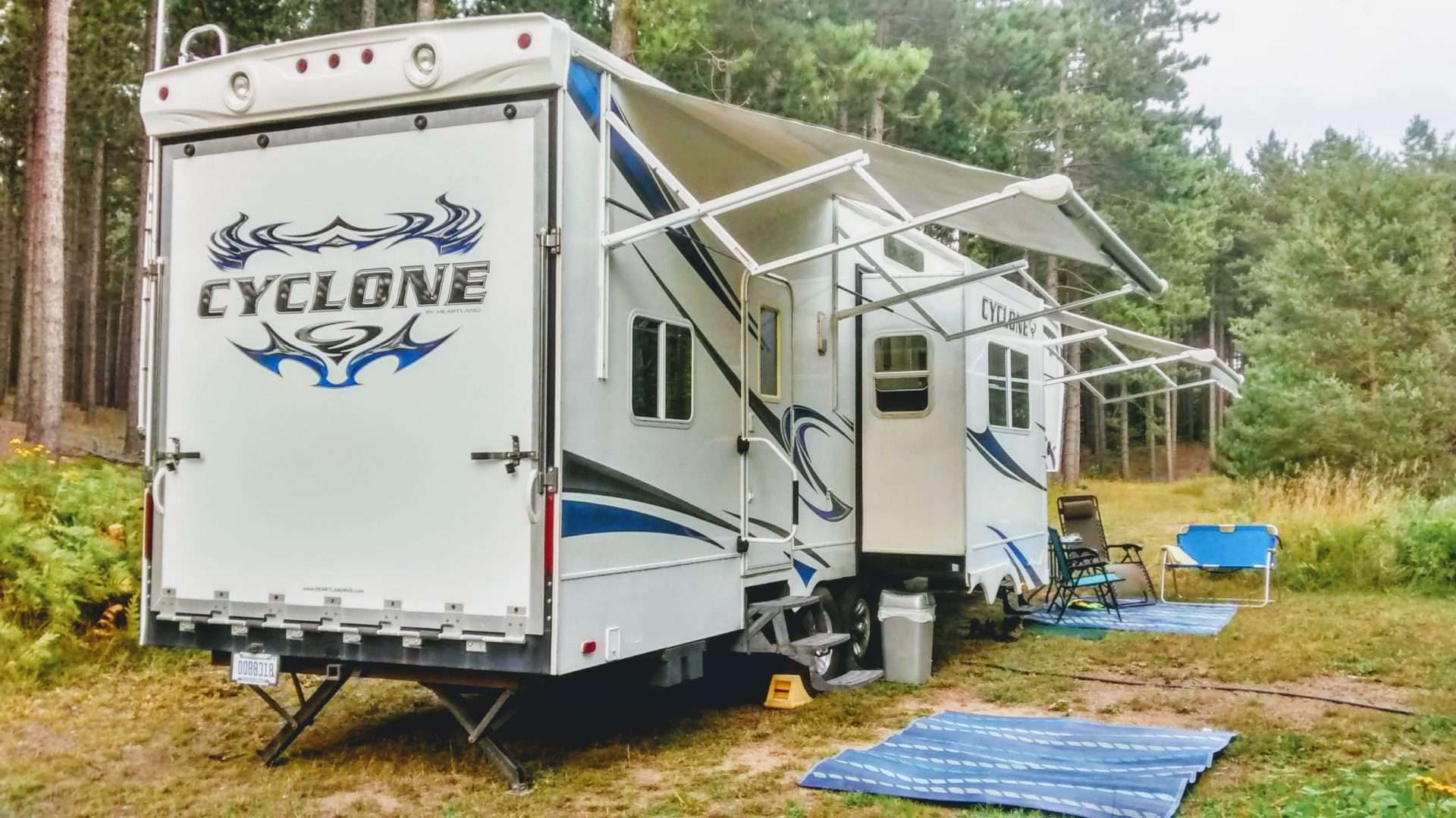 Cyclone RV with slide-outs open at campsite