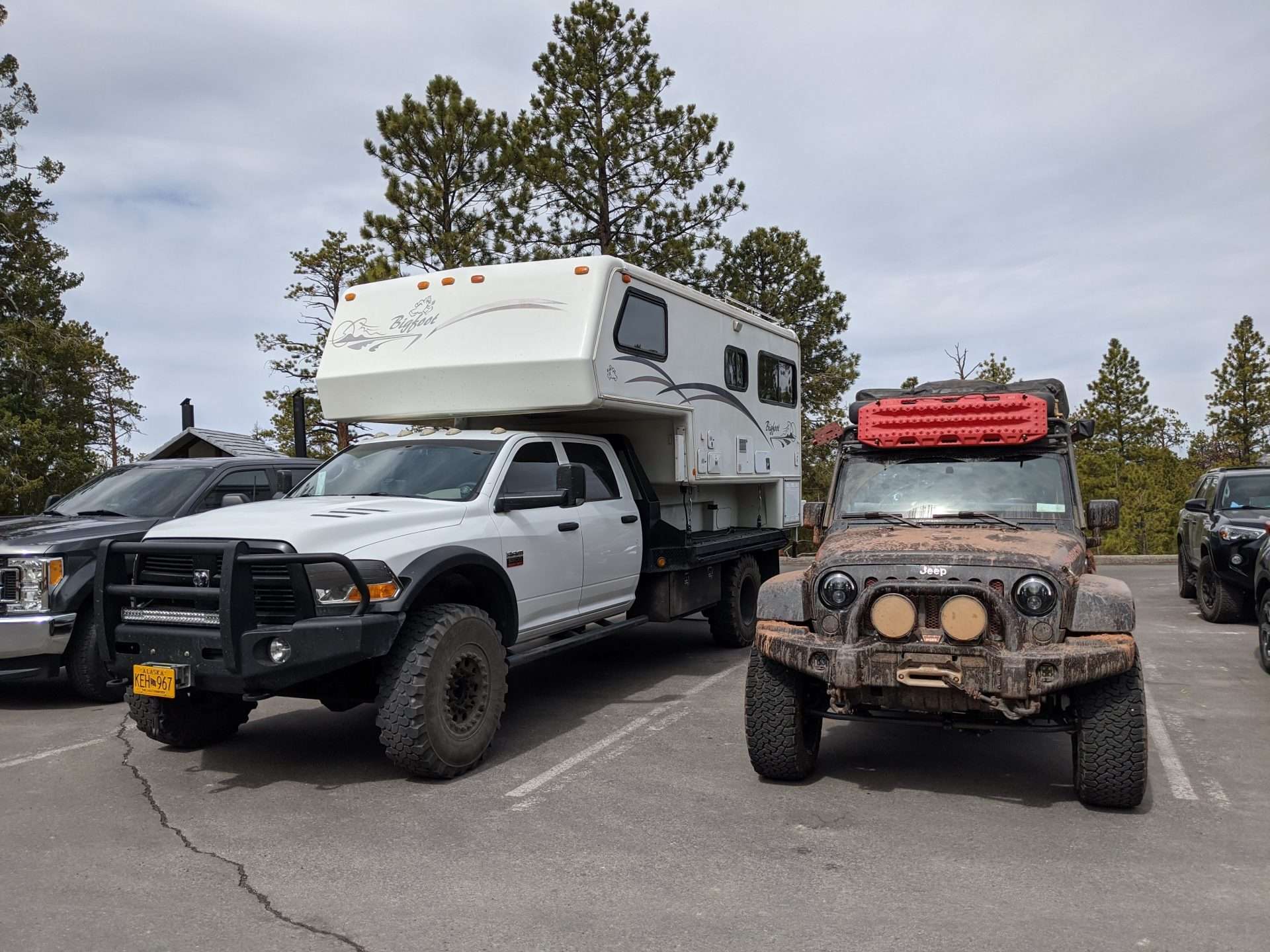 Overland truck camper next to off-road Jeep