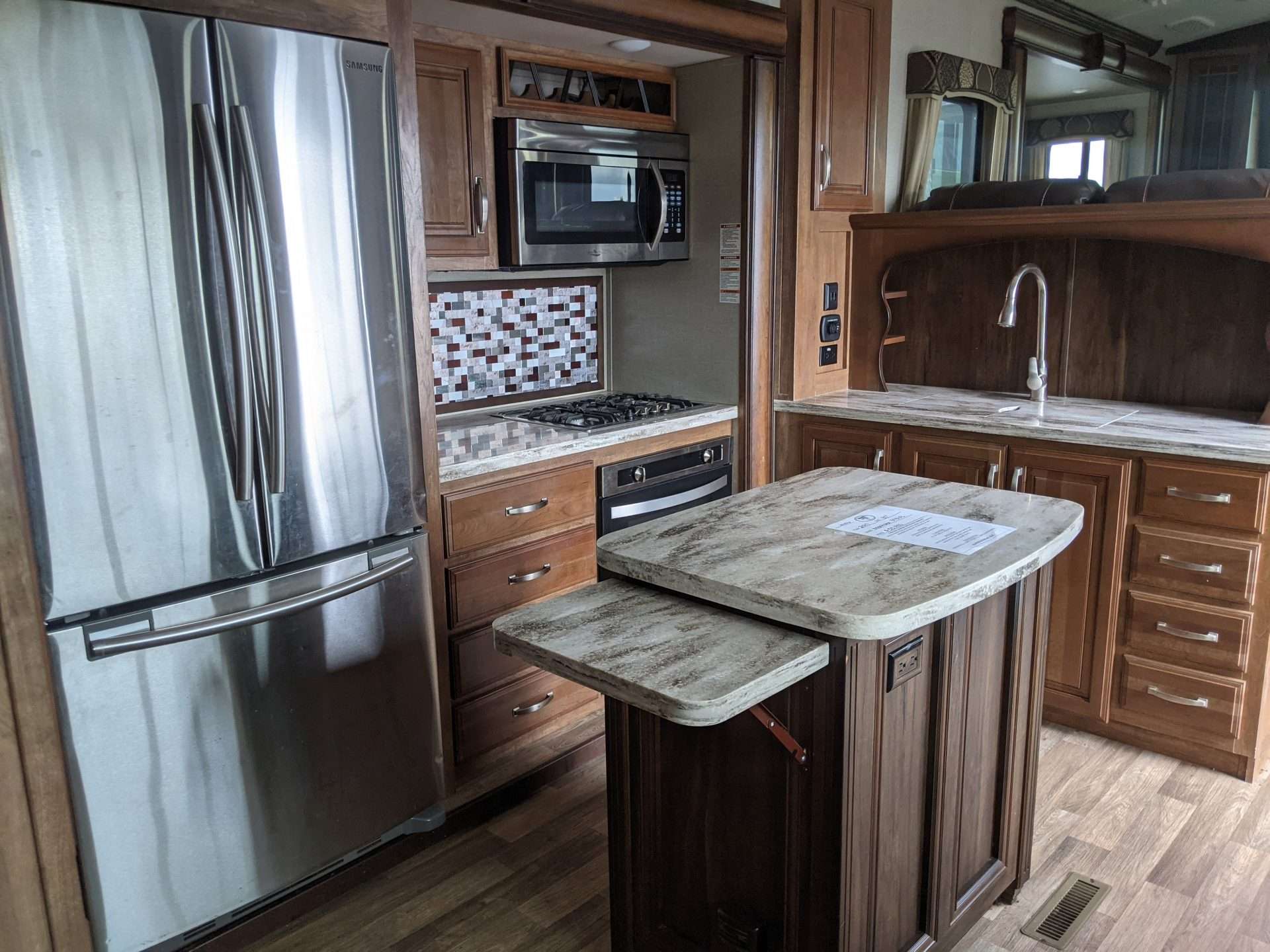 RV kitchen with kitchen island and installed countertop extension.