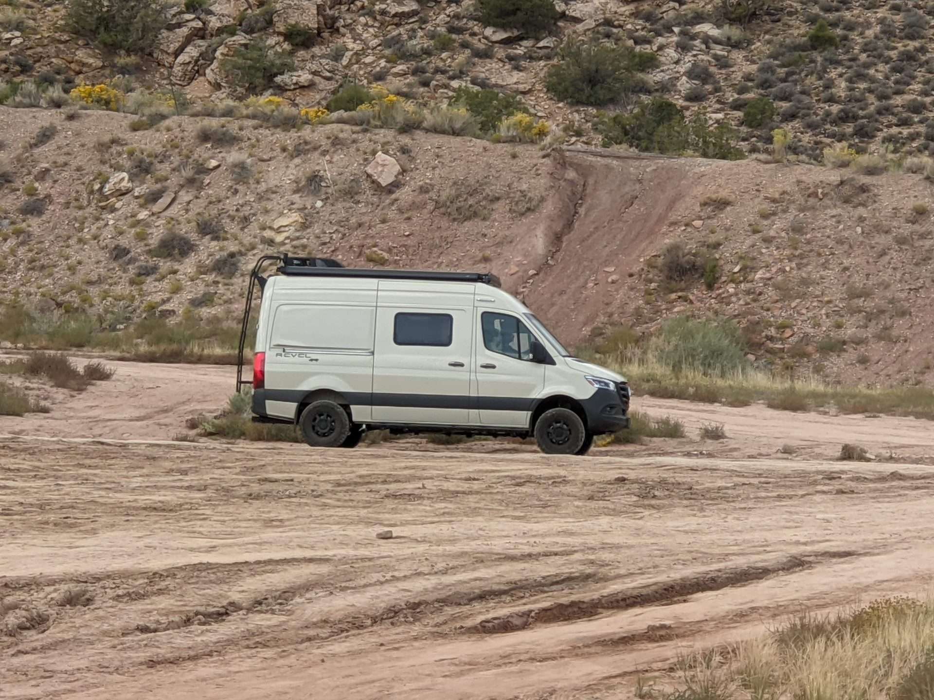 White campervan off-roading on a dirt road