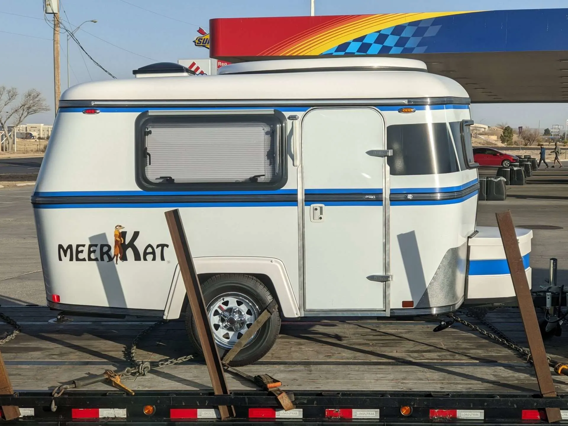 Meerkat camper trailer parked at gas station