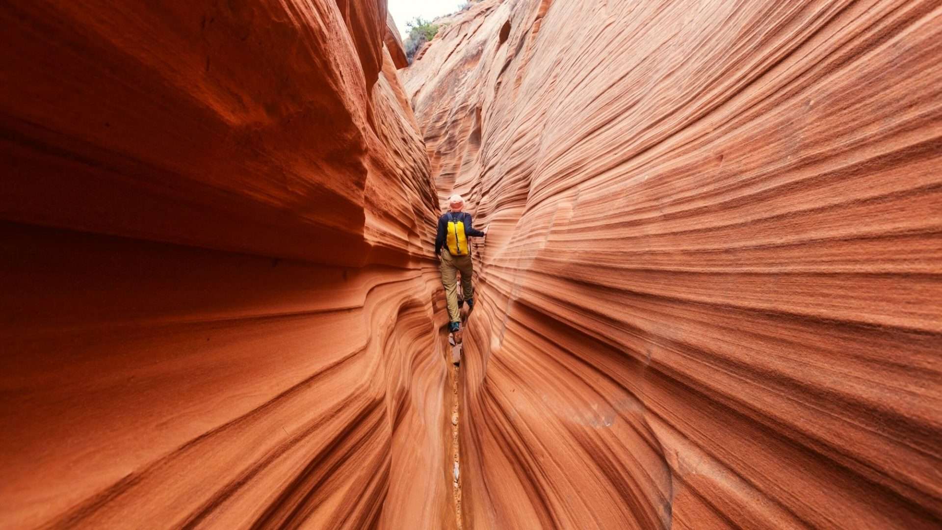 person hiking through narrow canyon in Arizona