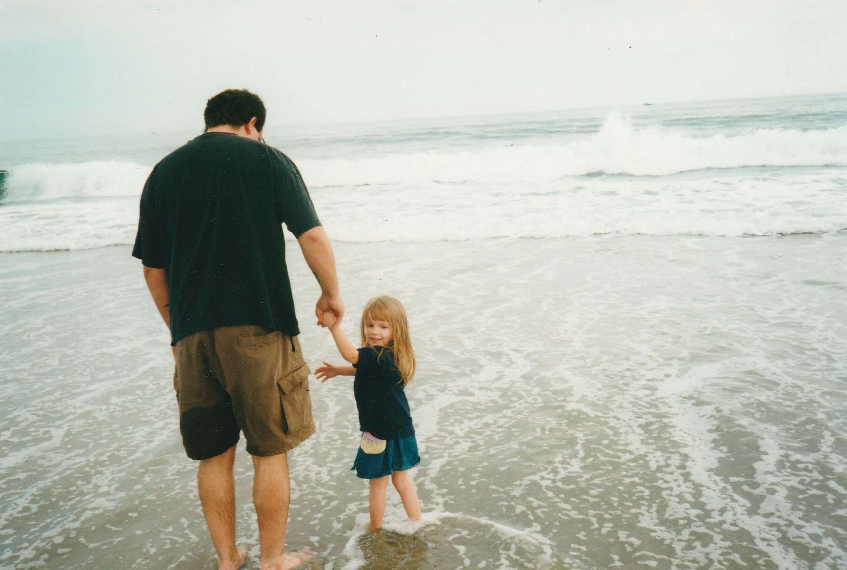 Dad and daughter walking into North Hampton State Beach together