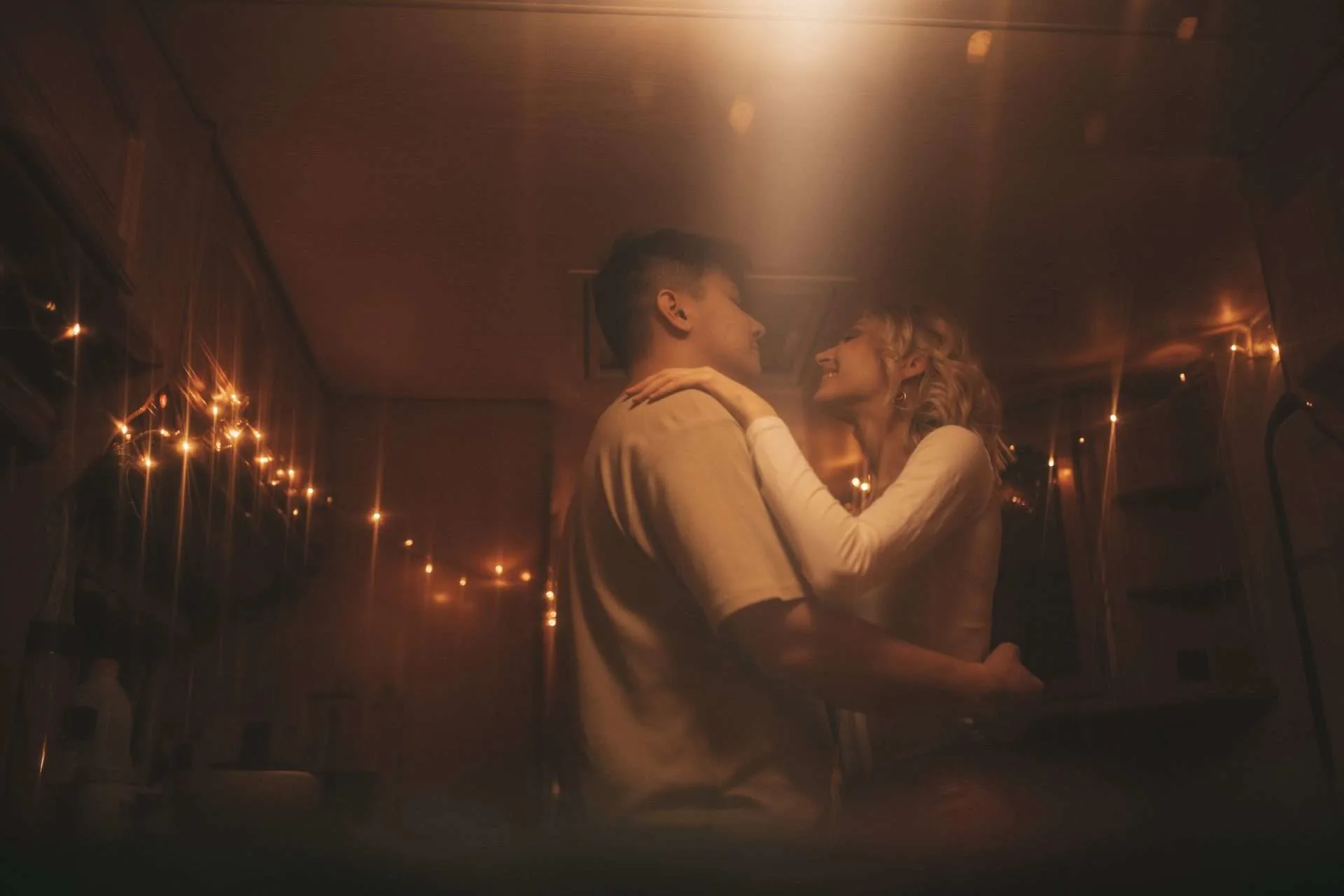 Couple dancing in RV with string lights installed inside