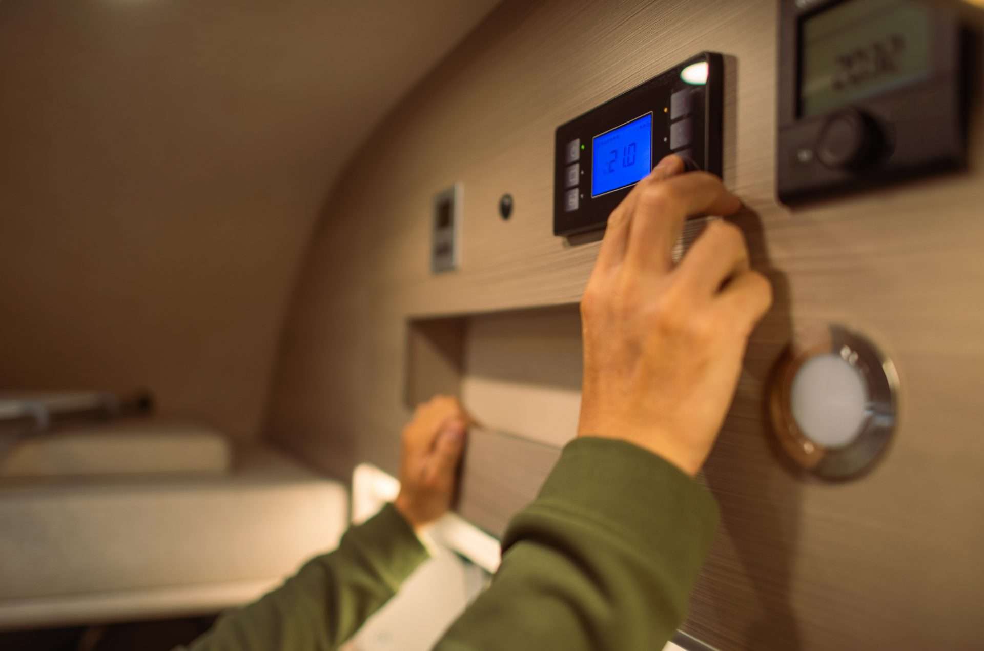 Man turning down temperature in RV