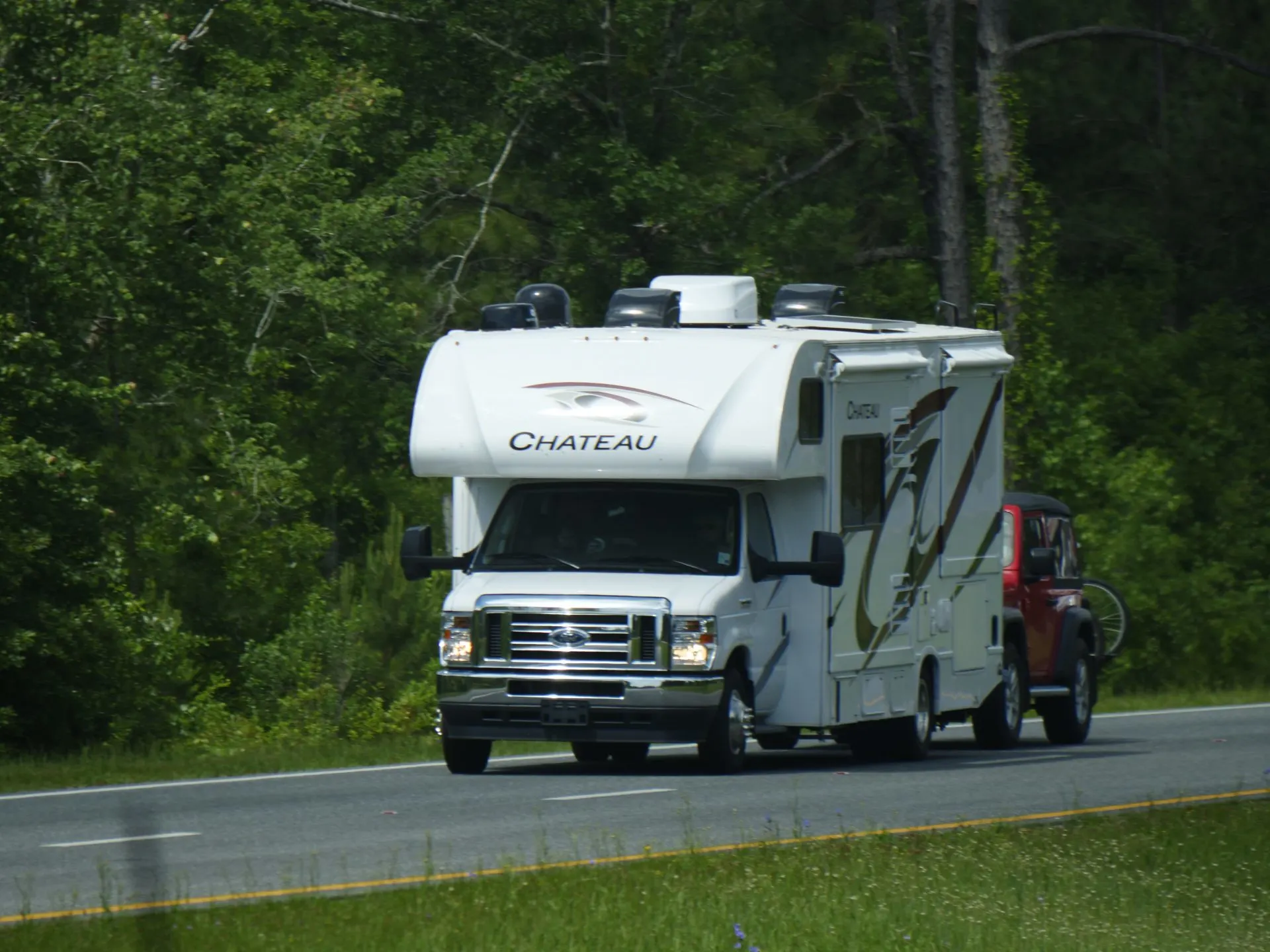Class C RV towing Jeep