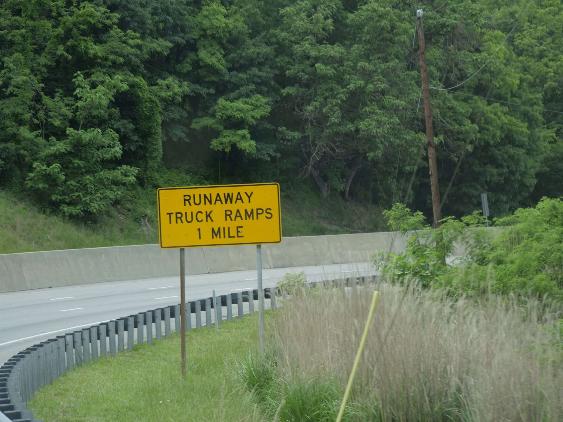 Runaway truck ramp in one mile sign along downhill hightway