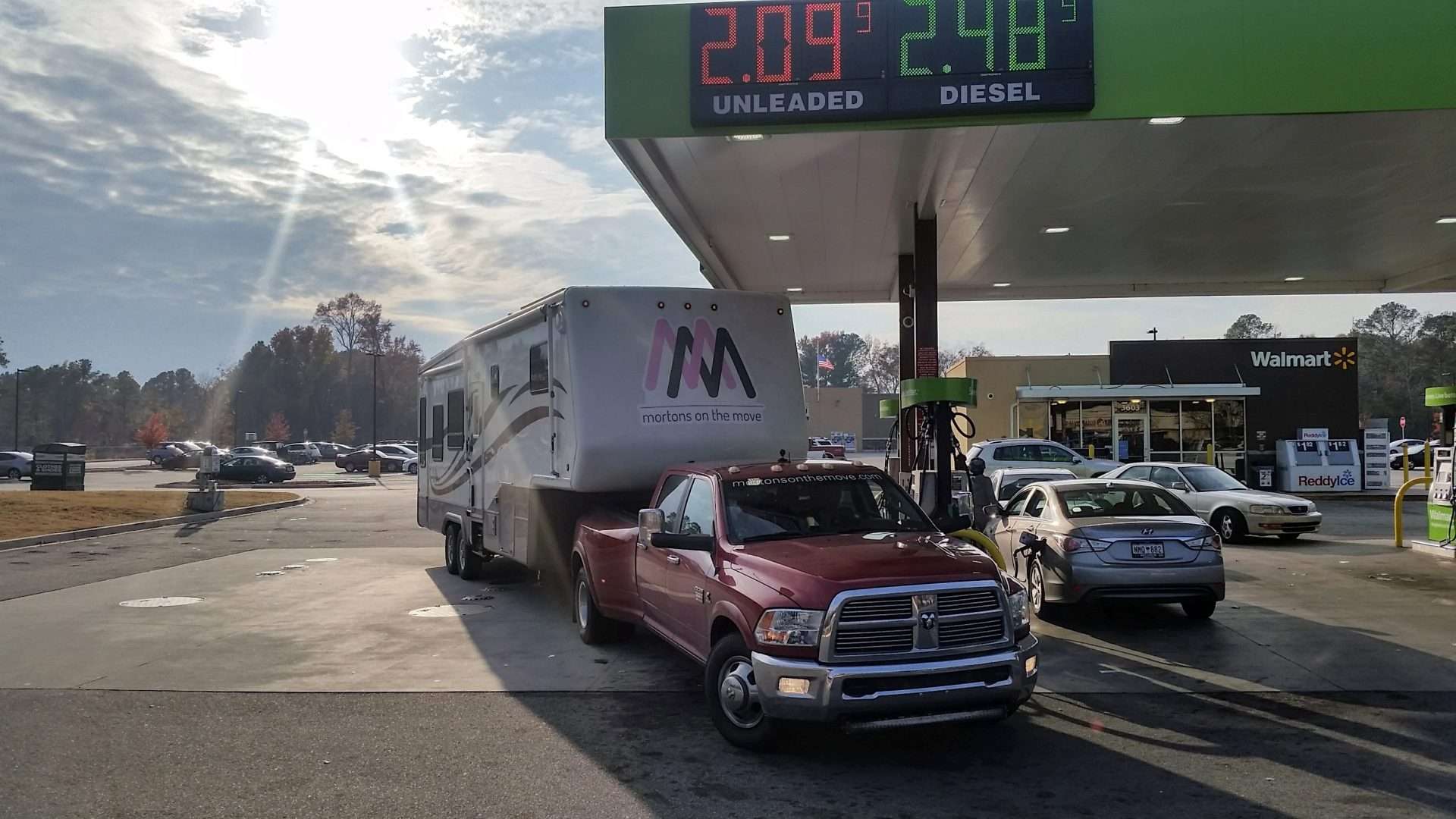 Mortons on the Move truck and fifth wheel at gas station refueling 