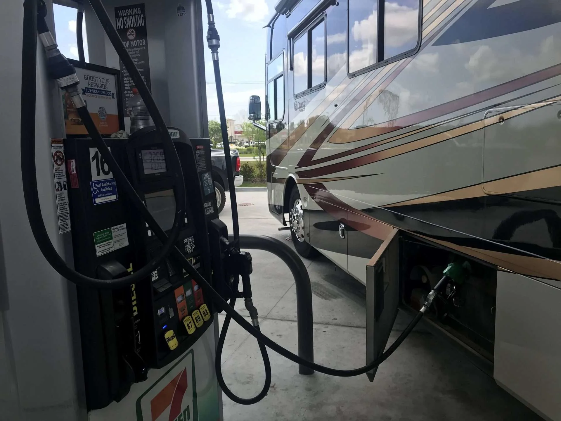 Motorhome parked at gas pump refueling.
