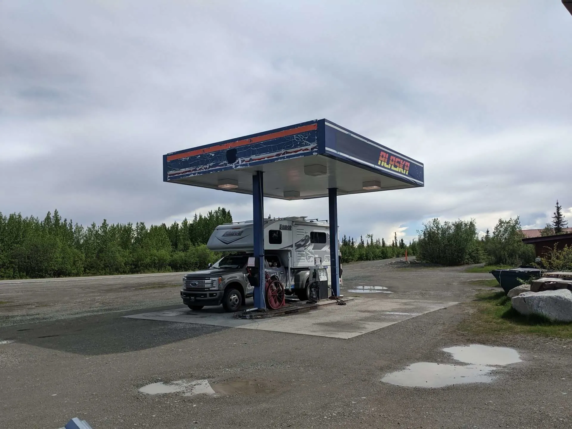 Truck camper refueling at gas station