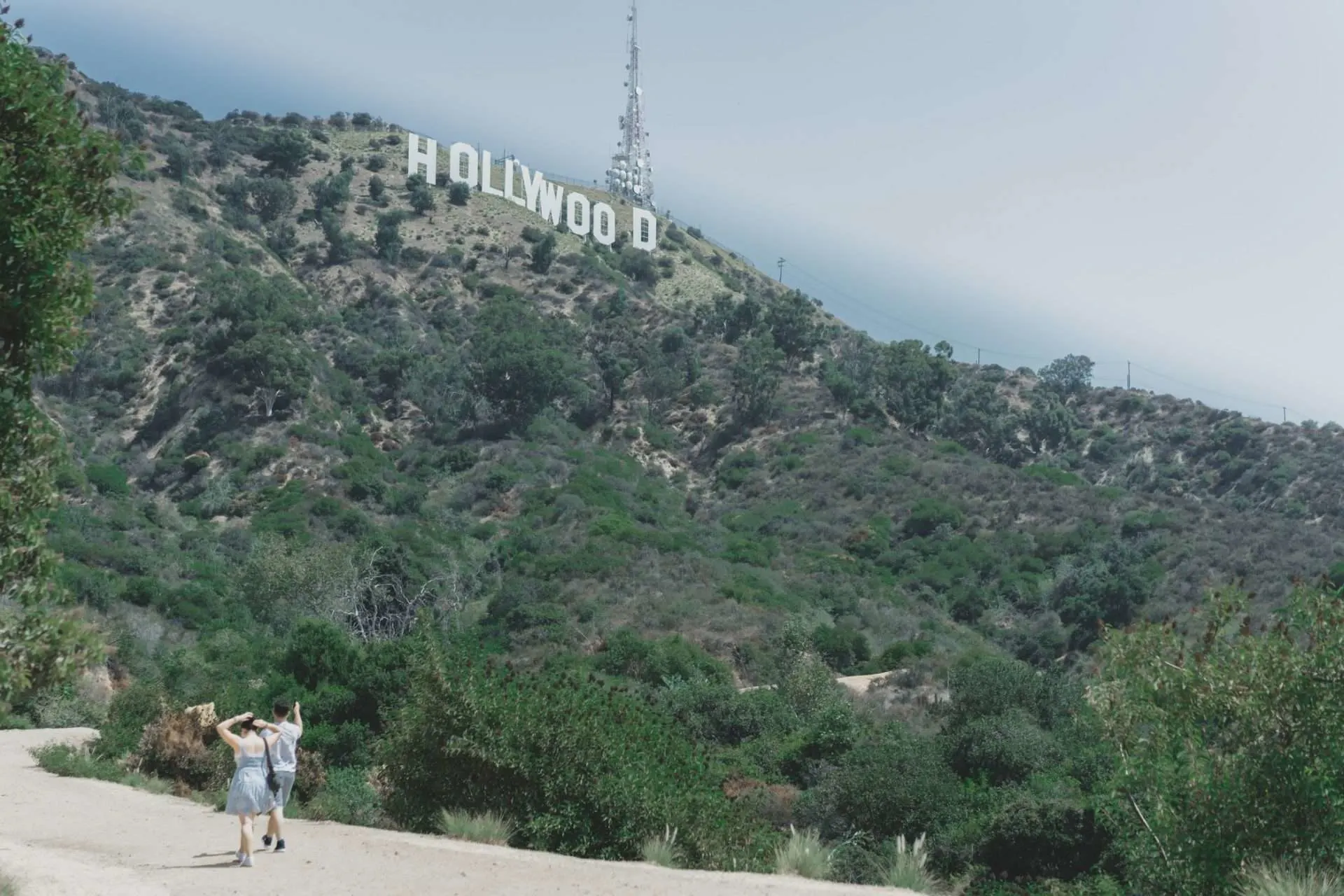 Couple hiking trail up to Hollywood sign 