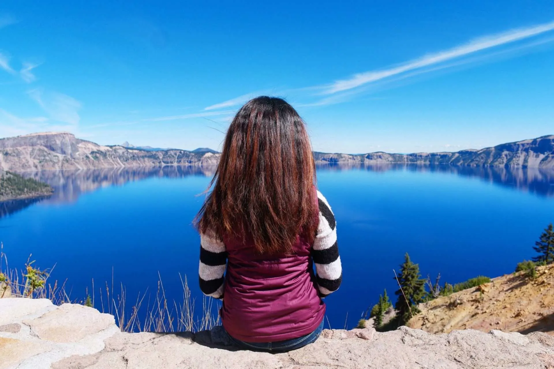 Woman looking out at the view of Crater Lake