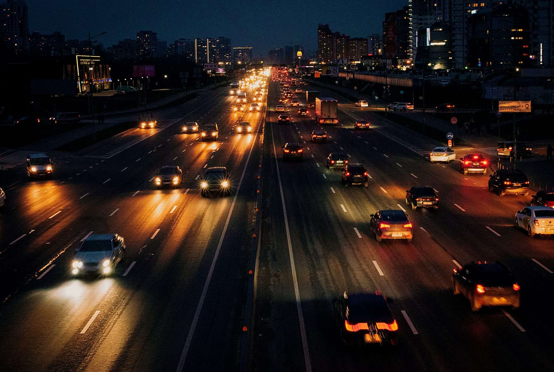 Busy highway at night with bright headlights
