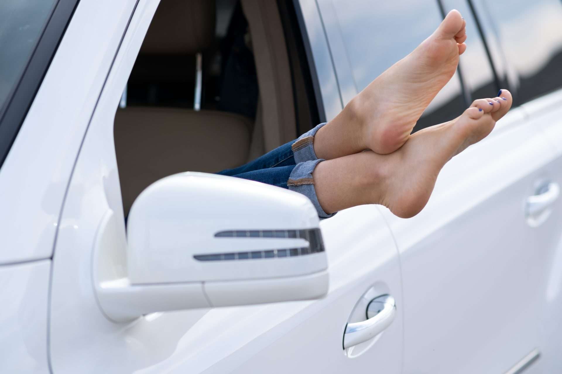 bare feet sticking out of car window