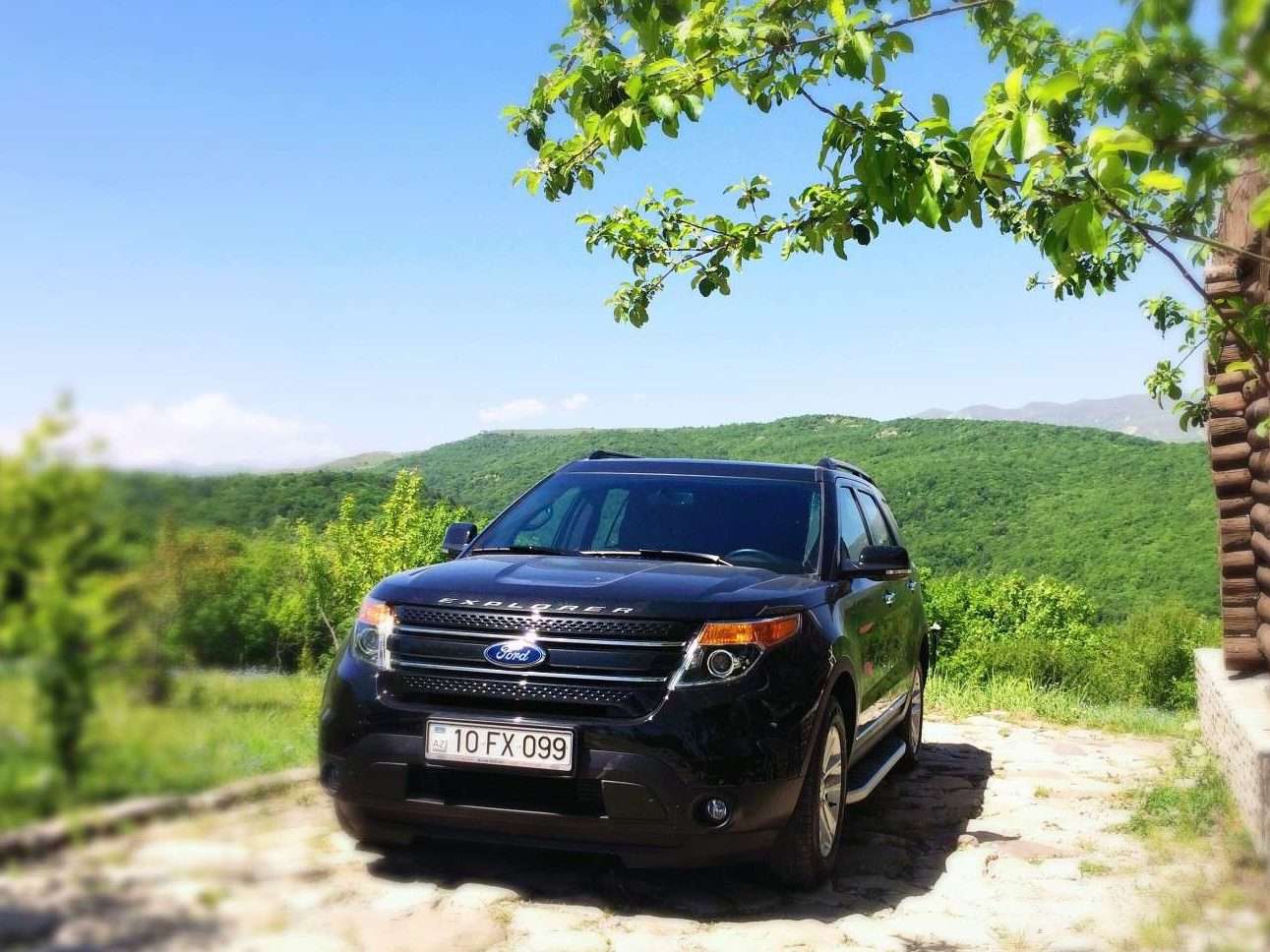 Black Ford Explorer parked in mountains