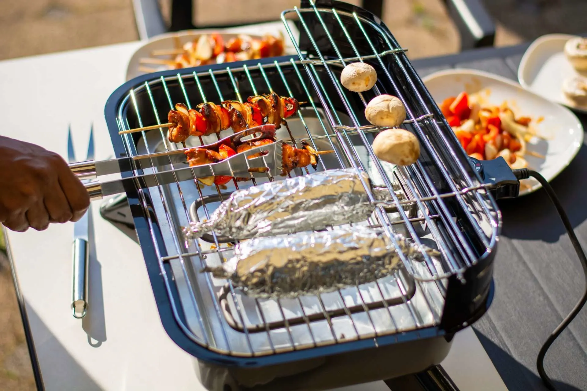 Portable electric grill making vegetables while camping