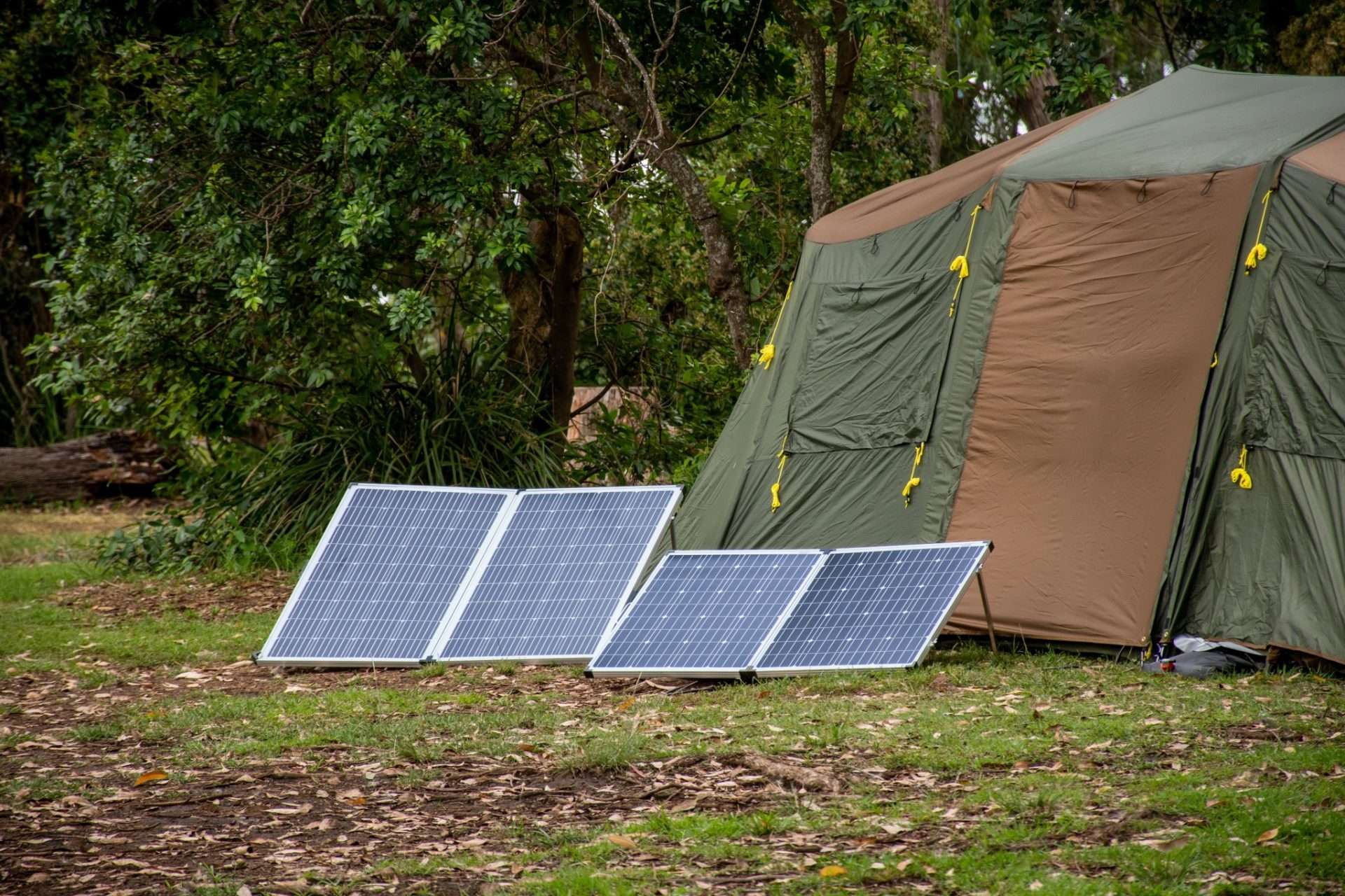 Portable solar panels set up in front of tent