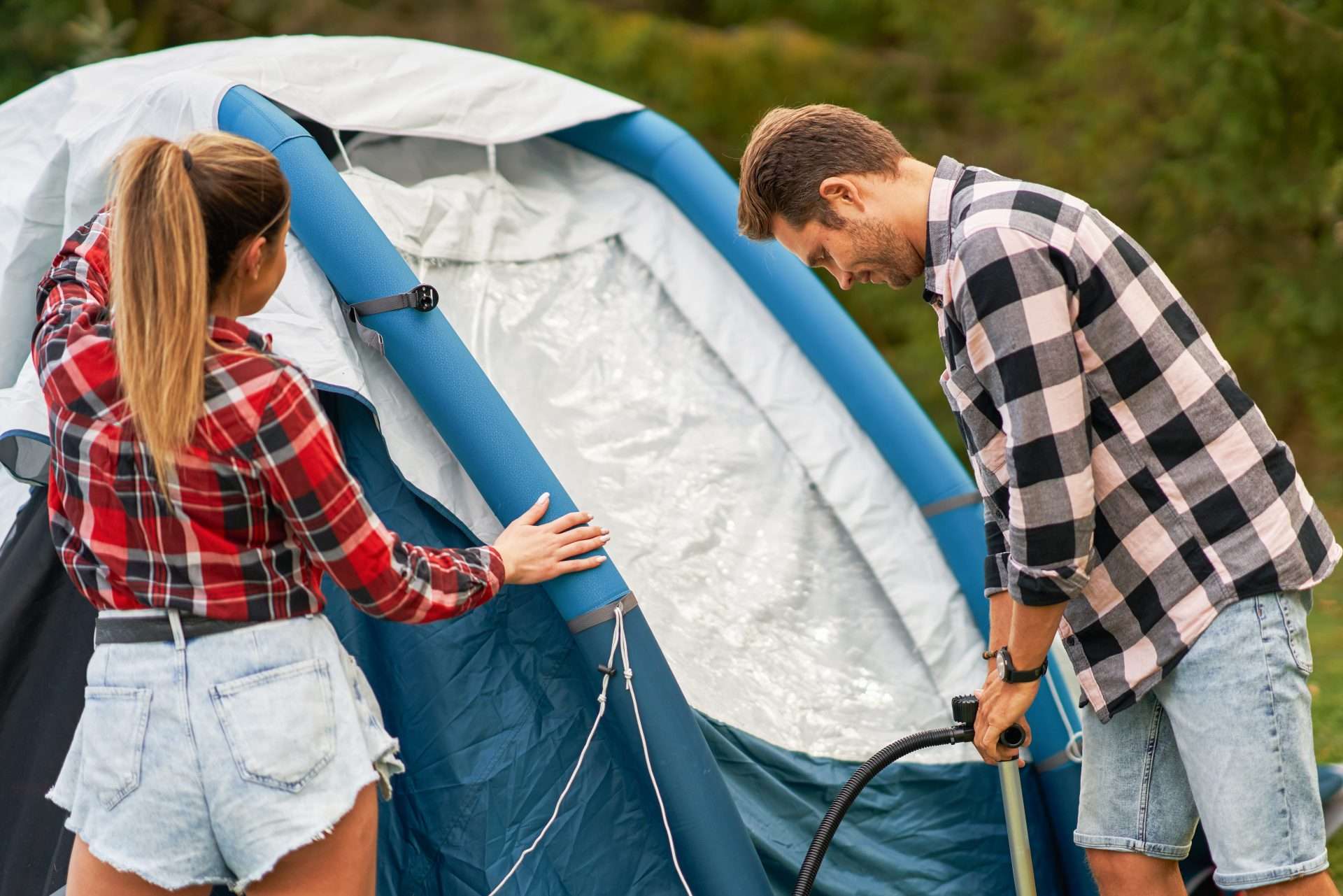 Couple building solar power tent together