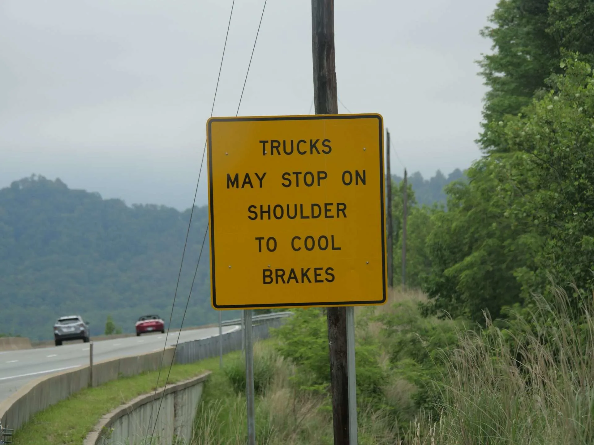trucks cool brakes on steep hill sign