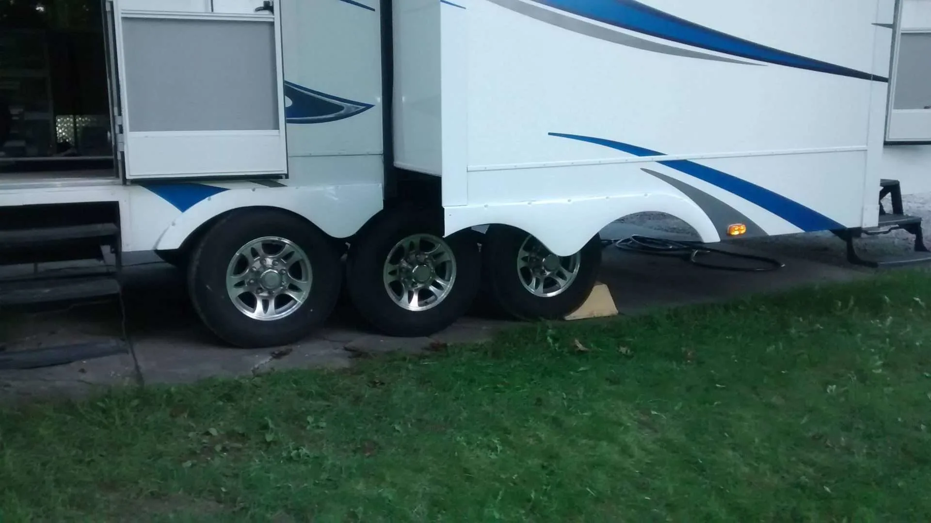 RV parked at campsite with wheel stabilizer.