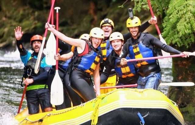 people standing up while white water rafting