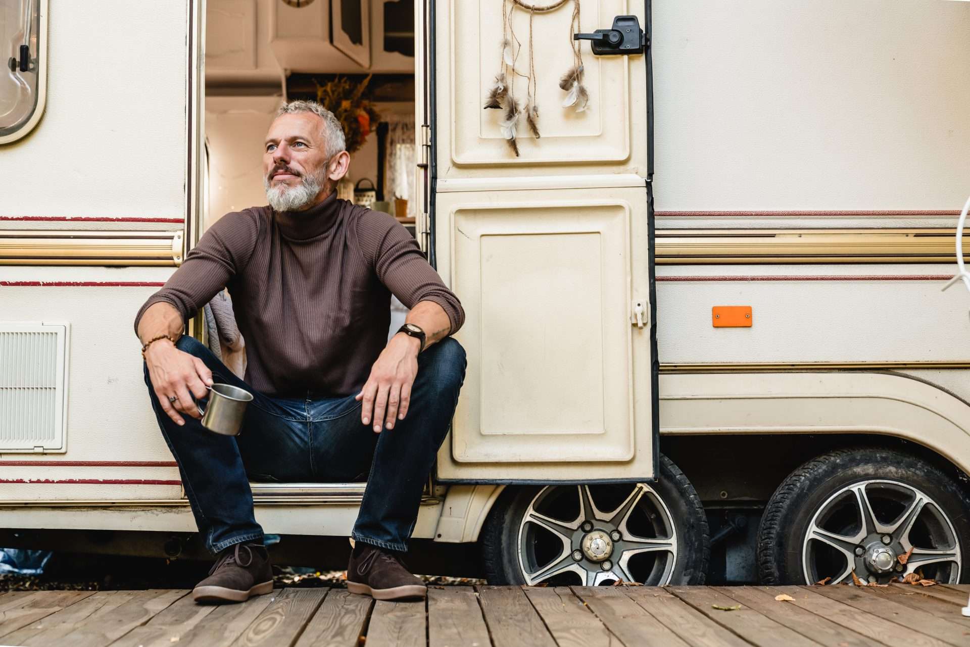 Older man posing in front of an RV